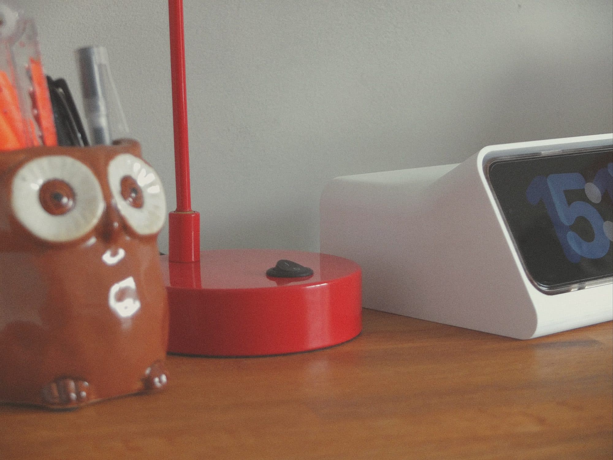 Desk ornaments of owl, lamp, and clock.